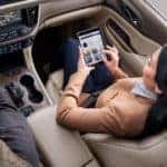 woman_sitting_in_passenger_seat_of_car_enrolling_in_My_GMC_Rewards_on_tablet_o