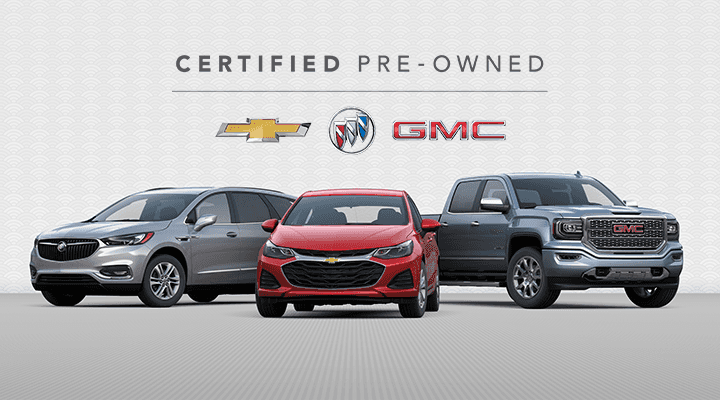 A buick, chevy, and gmc vehicle parked on a stage with a certified pre owned logo behind it