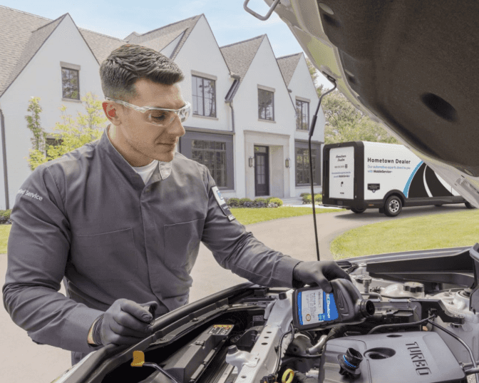 a mobile service plus technician completing an oil change at a customers house