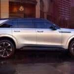 2025 Cadillac Escalade IQ driving on wet road