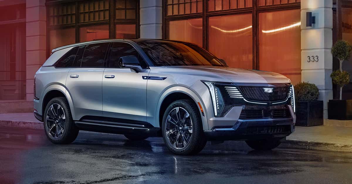 2025 Cadillac Escalade IQ driving on wet road