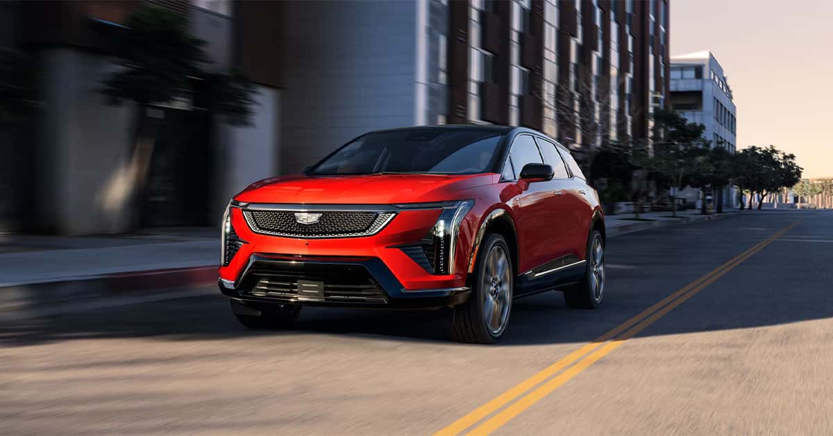 A red 2026 Cadillac OPTIQ on the road