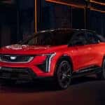 A red 2026 Cadillac OPTIQ parked outside a building