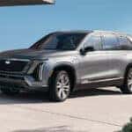 A silver 2026 Cadillac VISTIQ parked outside a building
