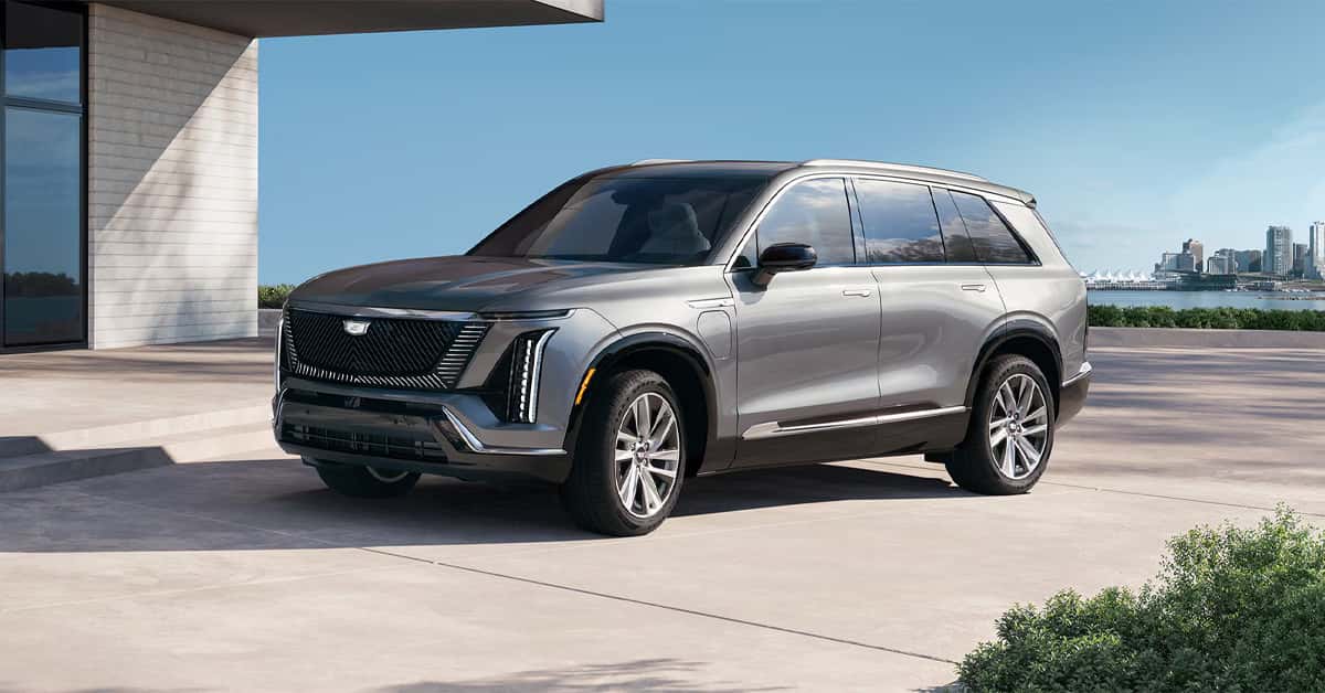 A silver 2026 Cadillac VISTIQ parked outside a building