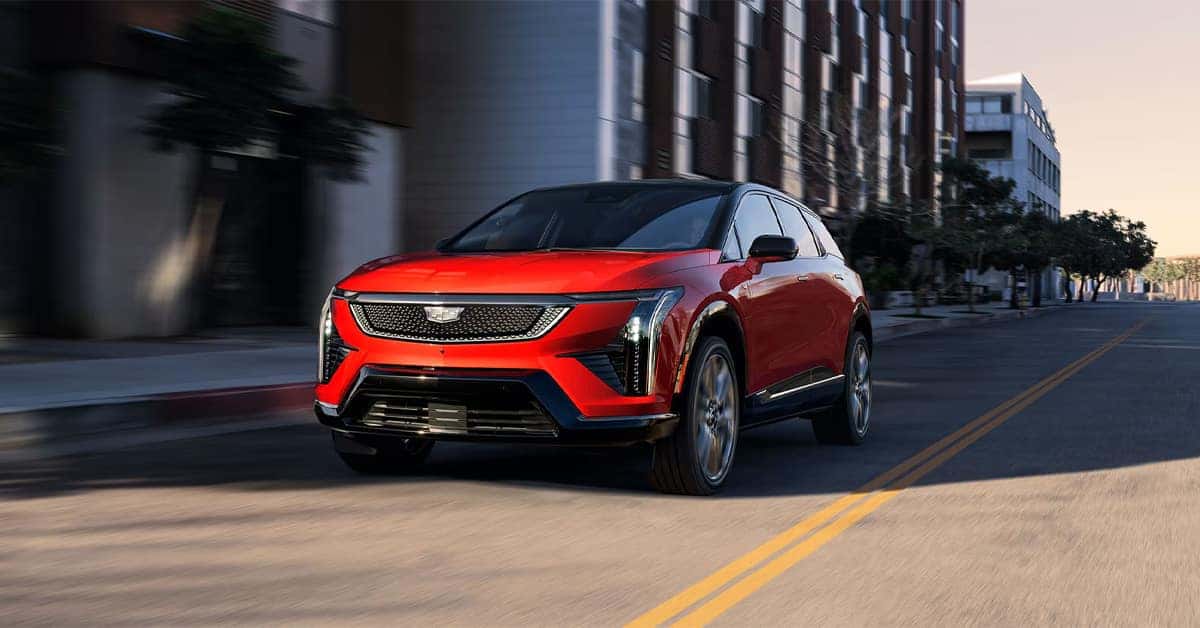 A red 2026 Cadillac Optiq in the road