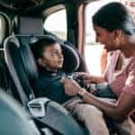 Child Being Buckled Into Car Seat