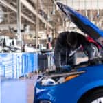 Mechanic working on Chevy parts under the hood