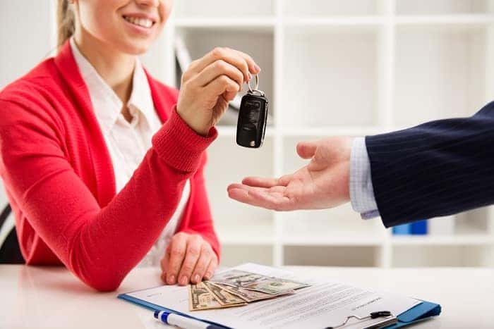 A person receiving their keys after signing a Chevrolet lease